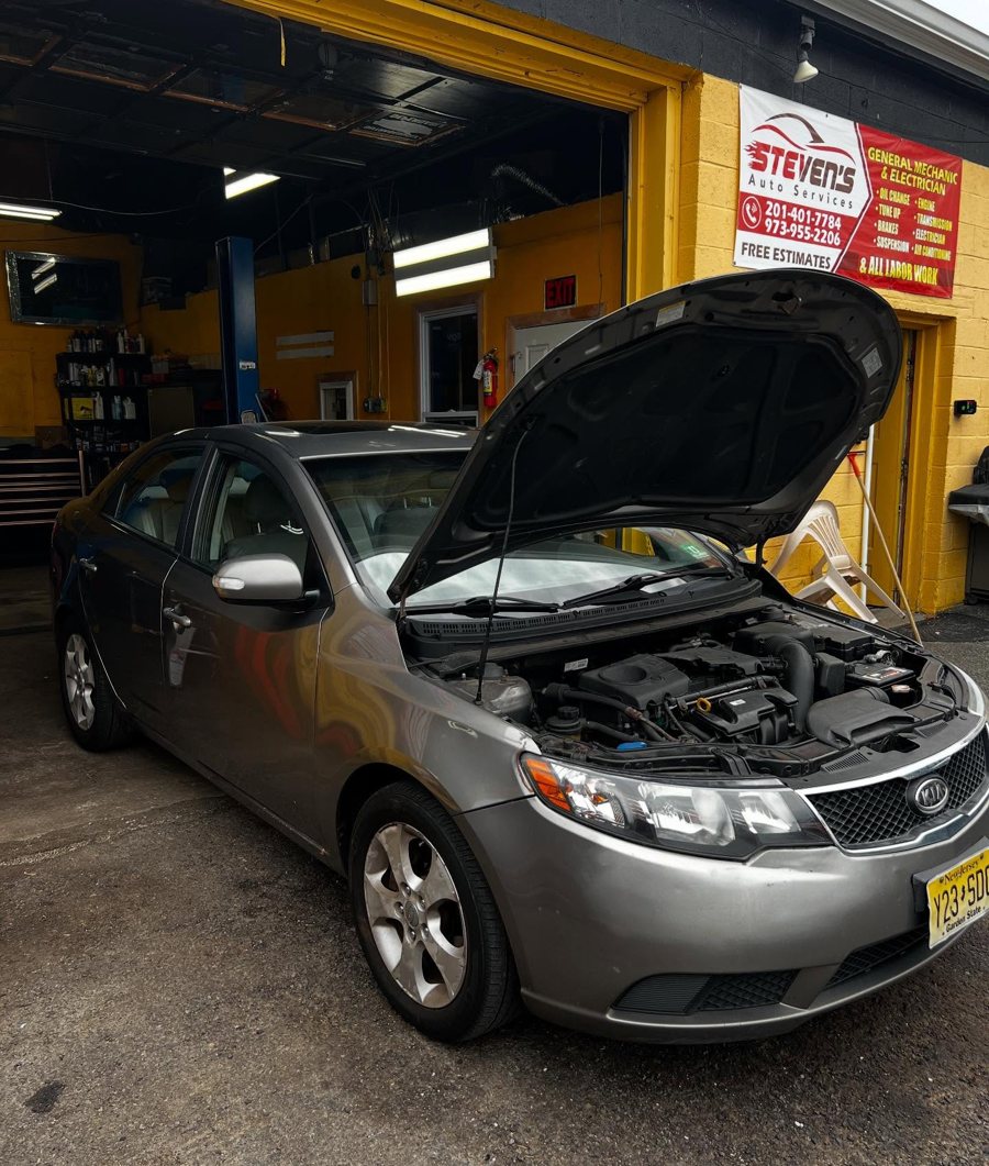 Sedan mid-service inside Stevens Auto